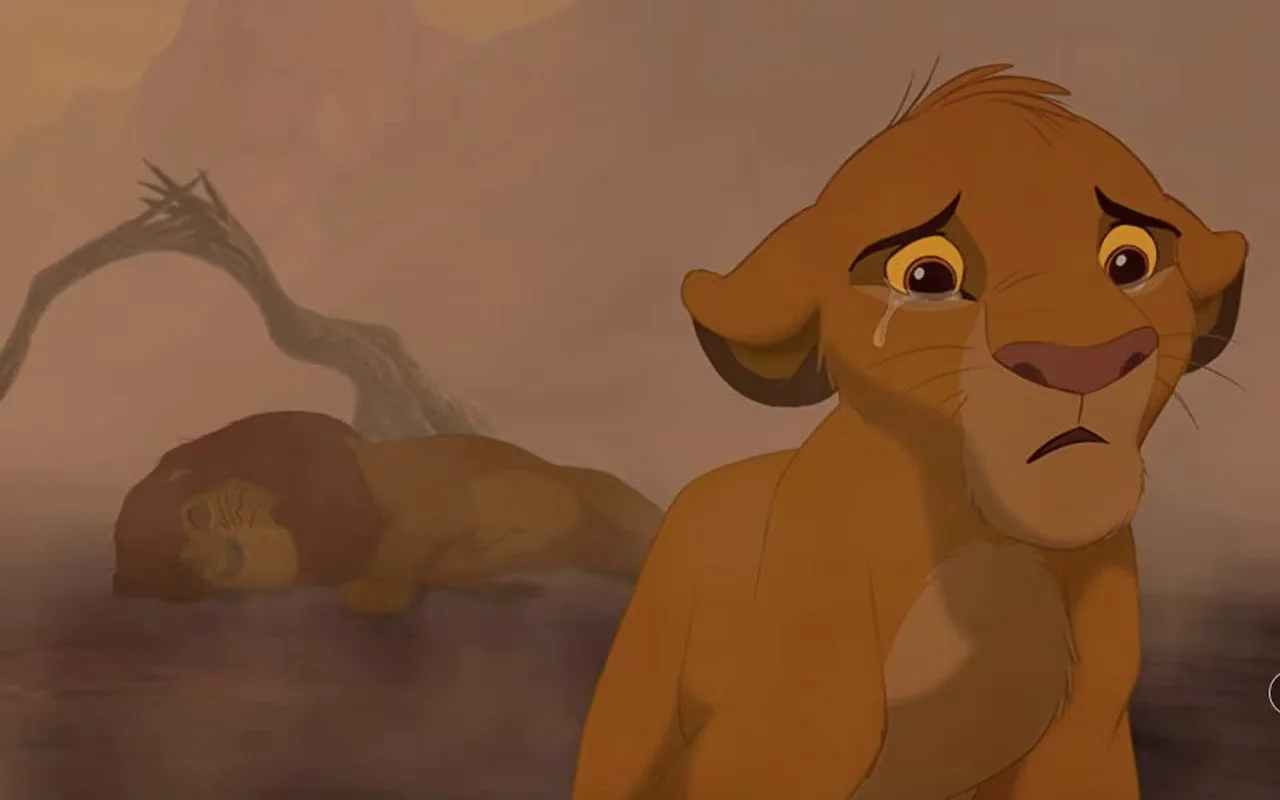 A scene from the lion king where Simba mourns the death of Mufasa
